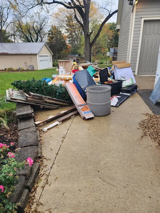 Dumpster being loaded with debris for Commercial Dumpster Rental in Cold Springs